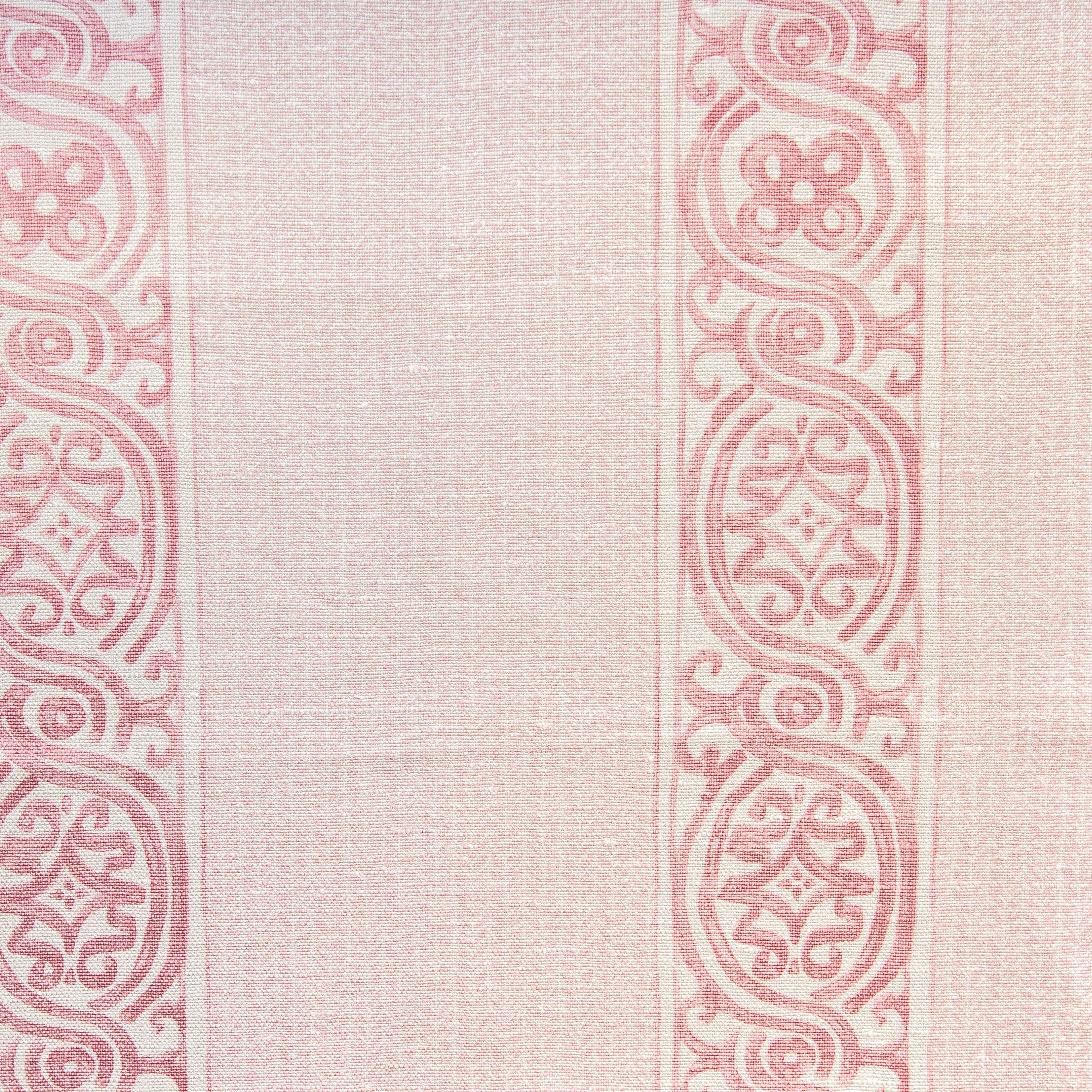 Detail of fabric in a painterly stripe print in shades of pink on a cream field.