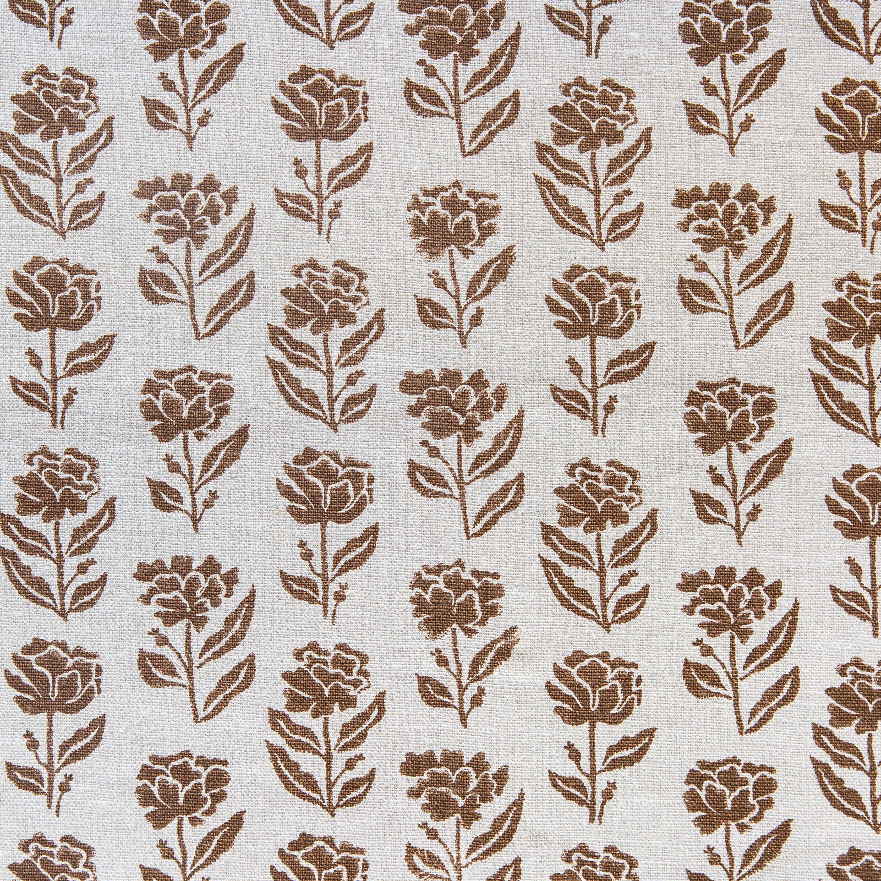 Detail of fabric in a classic floral print in brown on a cream field.