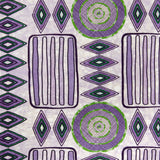 Detail of fabric in a playful geometric stripe print in shades of purple with green accents.