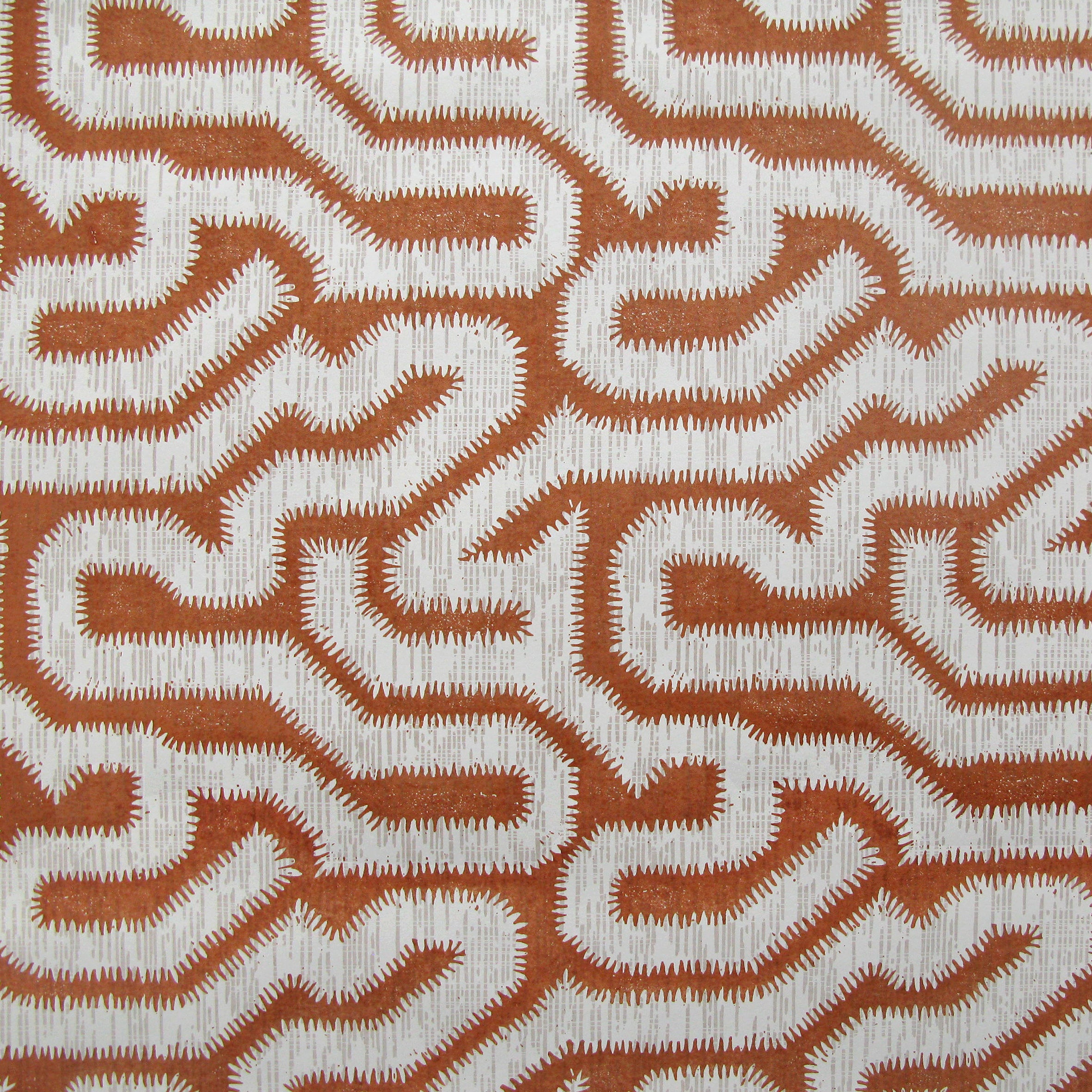 Detail of wallpaper in a playful meandering print in white on a sienna field.