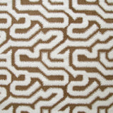 Detail of fabric in a playful meandering print in white on a brown field.