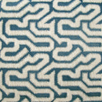 Detail of wallpaper in a playful meandering print in cream on a navy field.