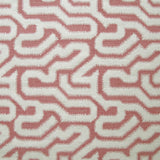 Detail of fabric in a playful meandering print in cream on a dusty rose field.