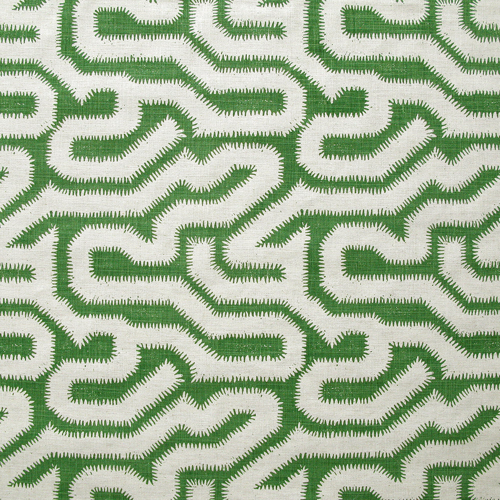 Detail of fabric in a playful meandering print in cream on a green field.