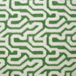 Detail of fabric in a playful meandering print in cream on a green field.