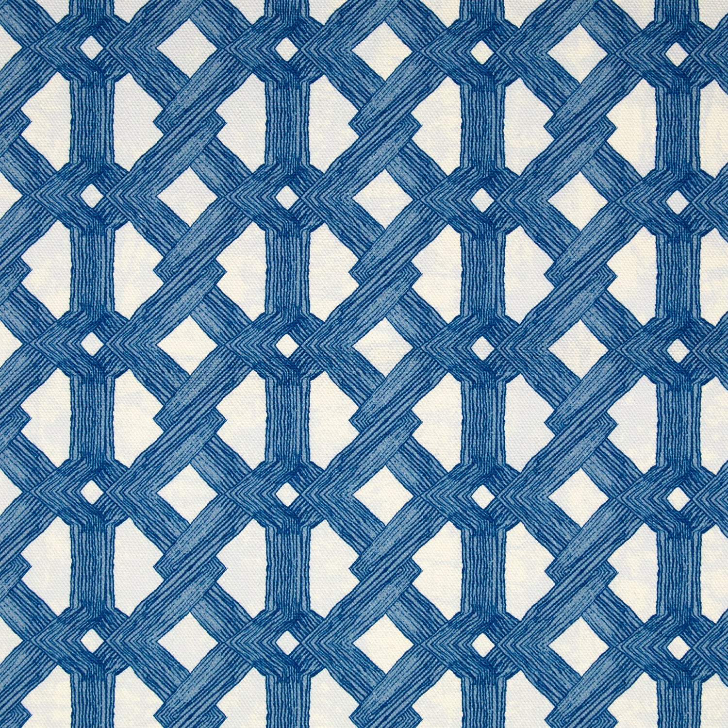 Detail of fabric in an intricate lattice print in navy on a cream field.