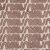Detail of fabric in an abstract curvilinear stripe in rust on a tan field.