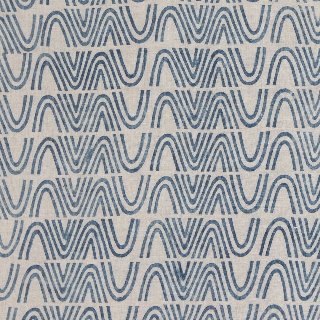 Detail of fabric in an abstract curvilinear stripe in blue on a tan field.