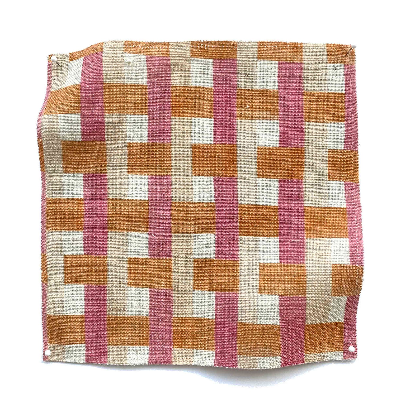 Square fabric swatch in an interlocking checked pattern in shades of tan, pink and orange.