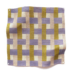 Square fabric swatch in an interlocking checked pattern in shades of pink, mustard and blue.