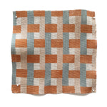 Square fabric swatch in an interlocking checked pattern in shades of tan, orange and blue.