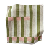 Square fabric swatch in an interlocking striped pattern in shades of olive, pink and cream.