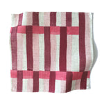 Square fabric swatch in an interlocking striped pattern in shades of pink, maroon and cream.