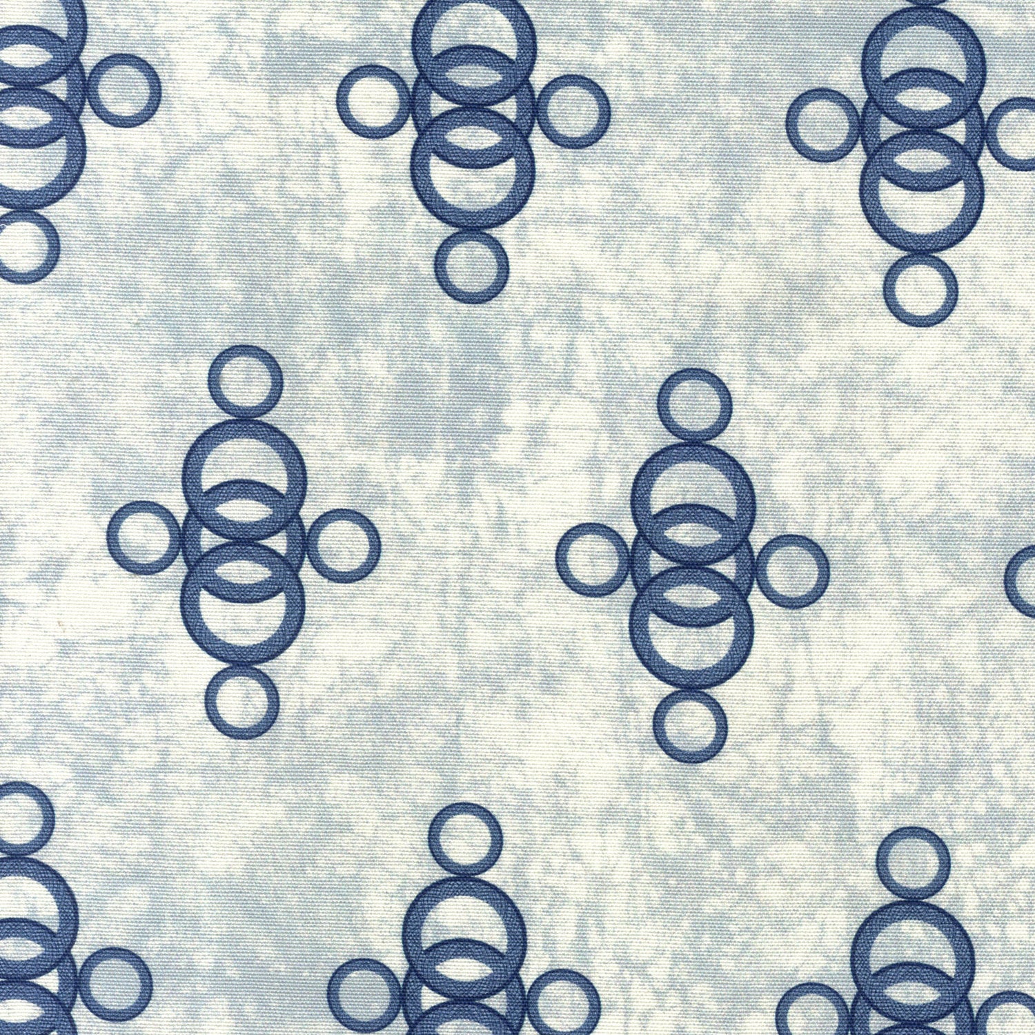 Detail of fabric in a curving lattice print in navy on a mottled blue field.
