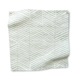 Square fabric swatch in a dense herringbone print in light green on a white field.
