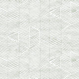 Detail of fabric in a dense herringbone print in light green on a white field.