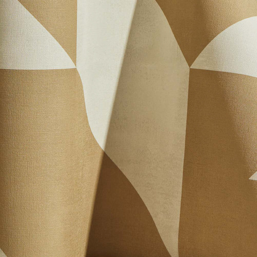 Draped wallpaper yardage in a large-scale geometric print in tan on a cream field.