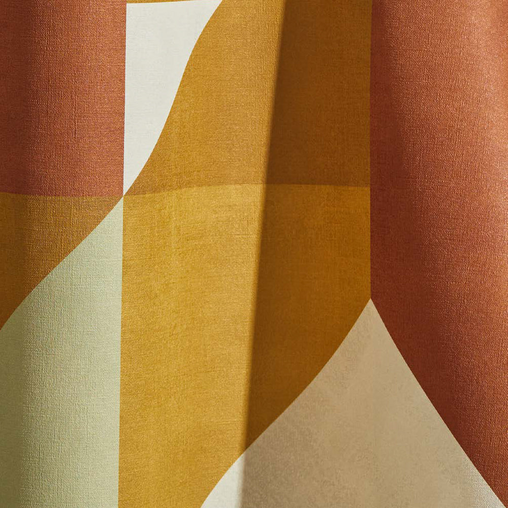 Draped wallpaper yardage in a large-scale geometric print in cream, mustard and rust.