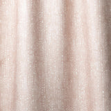 Draped linen in a painterly small-scale dashed dot print in white on a soft pink watercolor field.