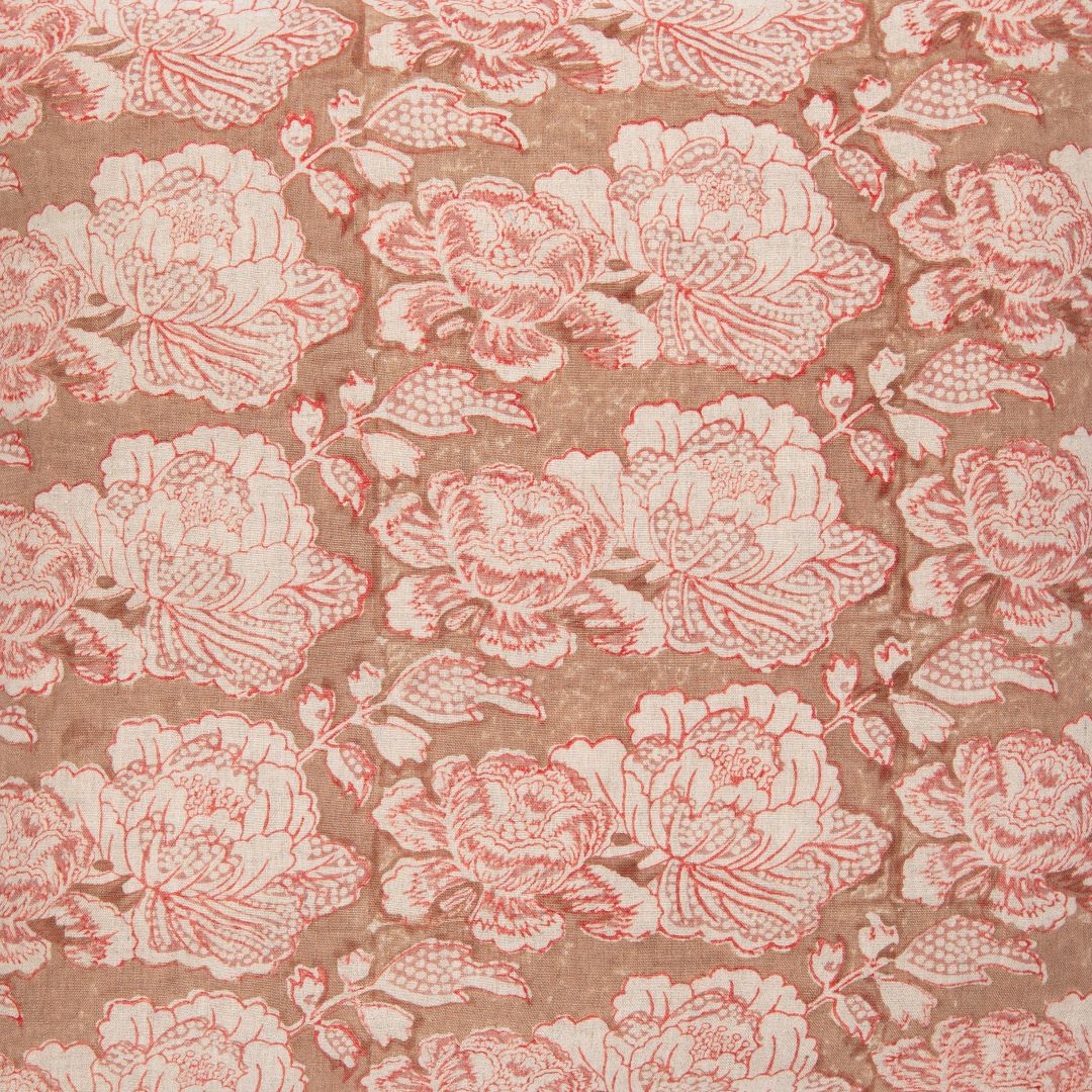 Detail of fabric in a floral print in cream and red on a brown field.