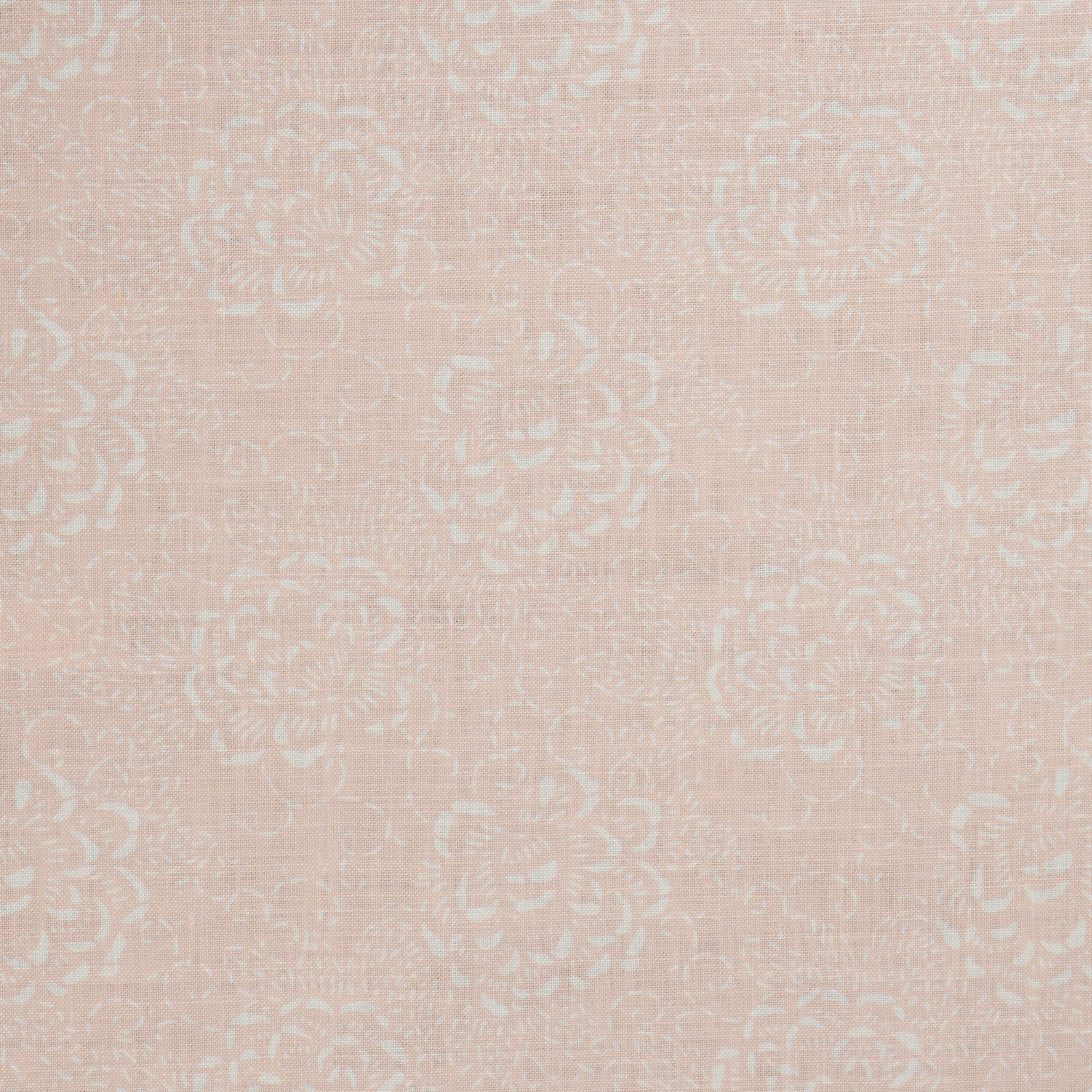 Detail of a printed linen fabric in a repeating camellia pattern in white on a light pink field.