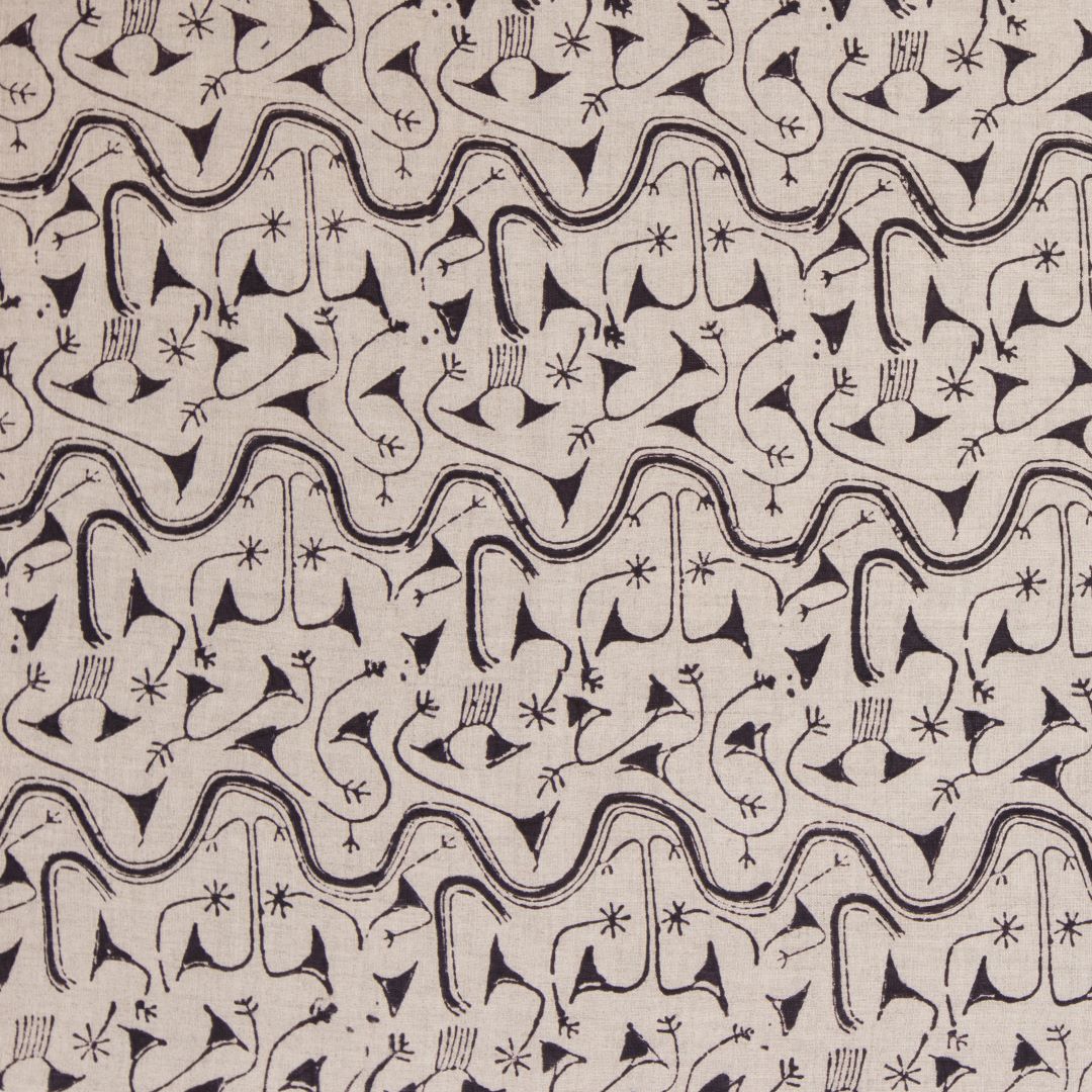 Detail of fabric in an abstract tribal print in black on a tan field.