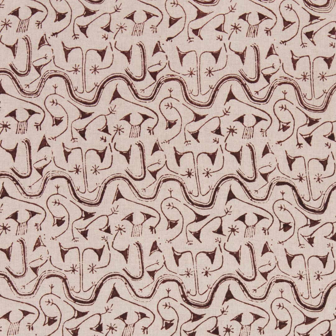 Detail of fabric in an abstract tribal print in rust on a tan field.