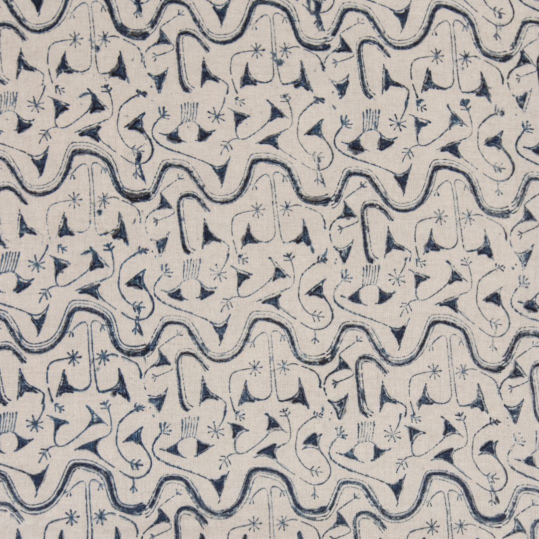 Detail of fabric in an abstract tribal print in navy on a tan field.