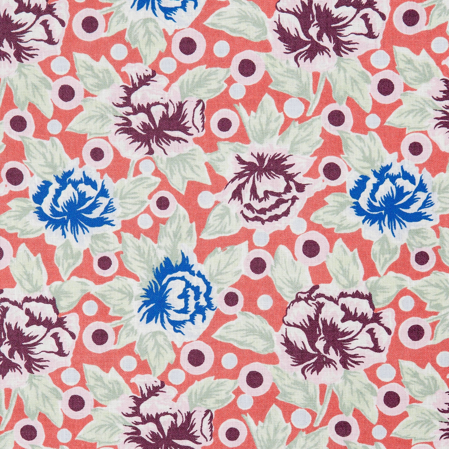 Detail of a printed linen fabric in a repeating china rose pattern in shades of pink, blue and cream on a coral field.