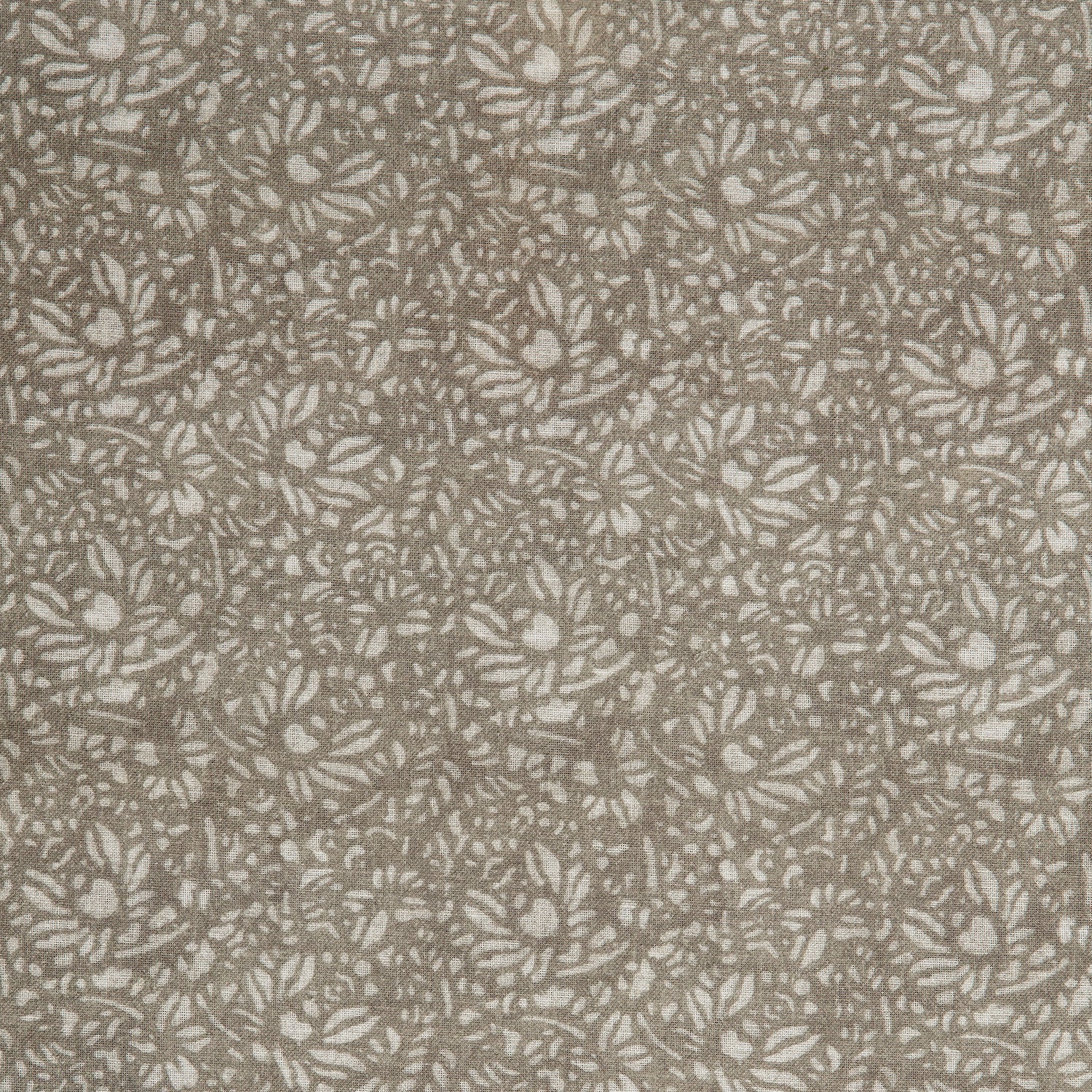 Detail of a printed linen fabric in a repeating chrysanthemum pattern in cream on a light brown field.