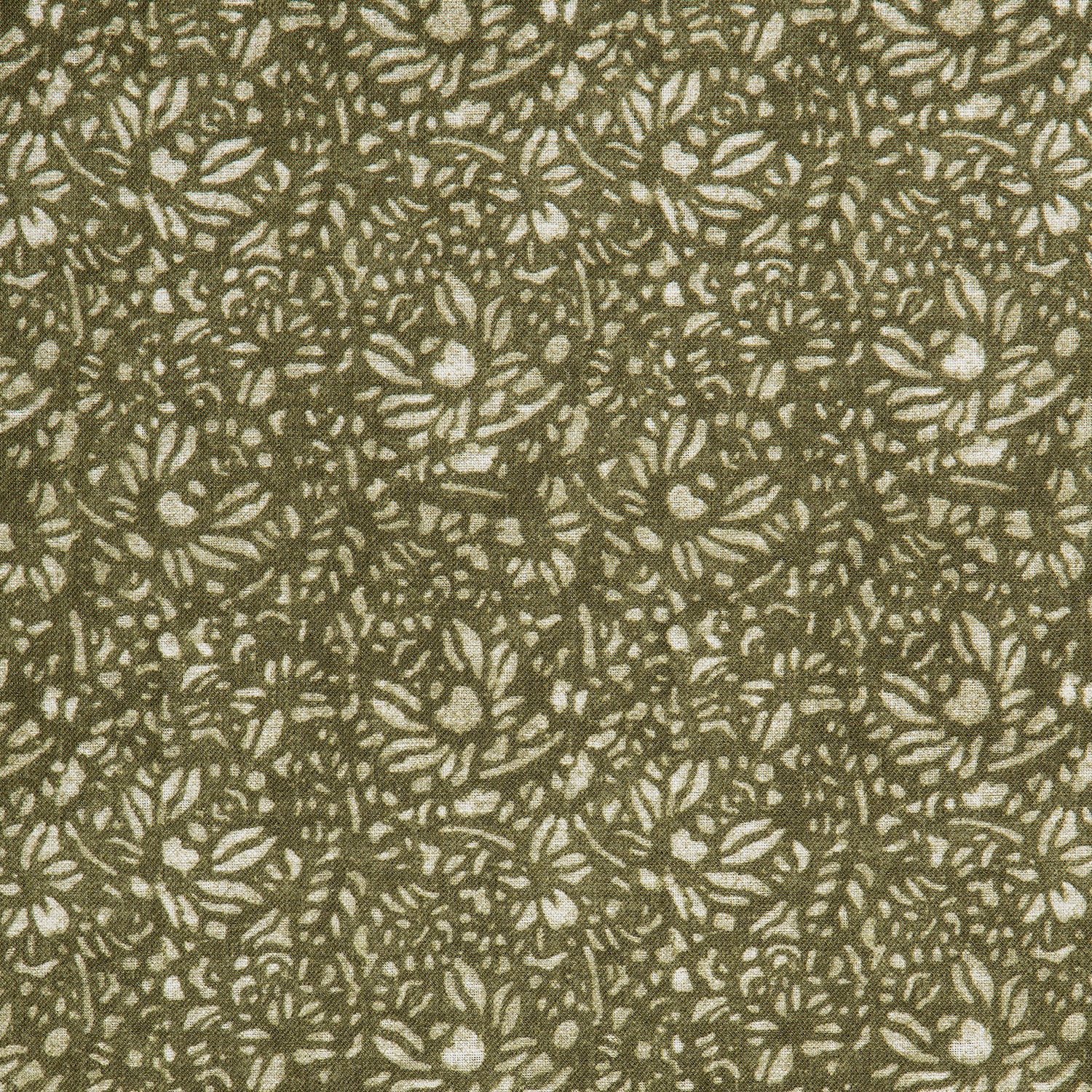 Detail of a printed linen fabric in a repeating chrysanthemum pattern in cream on an olive field.