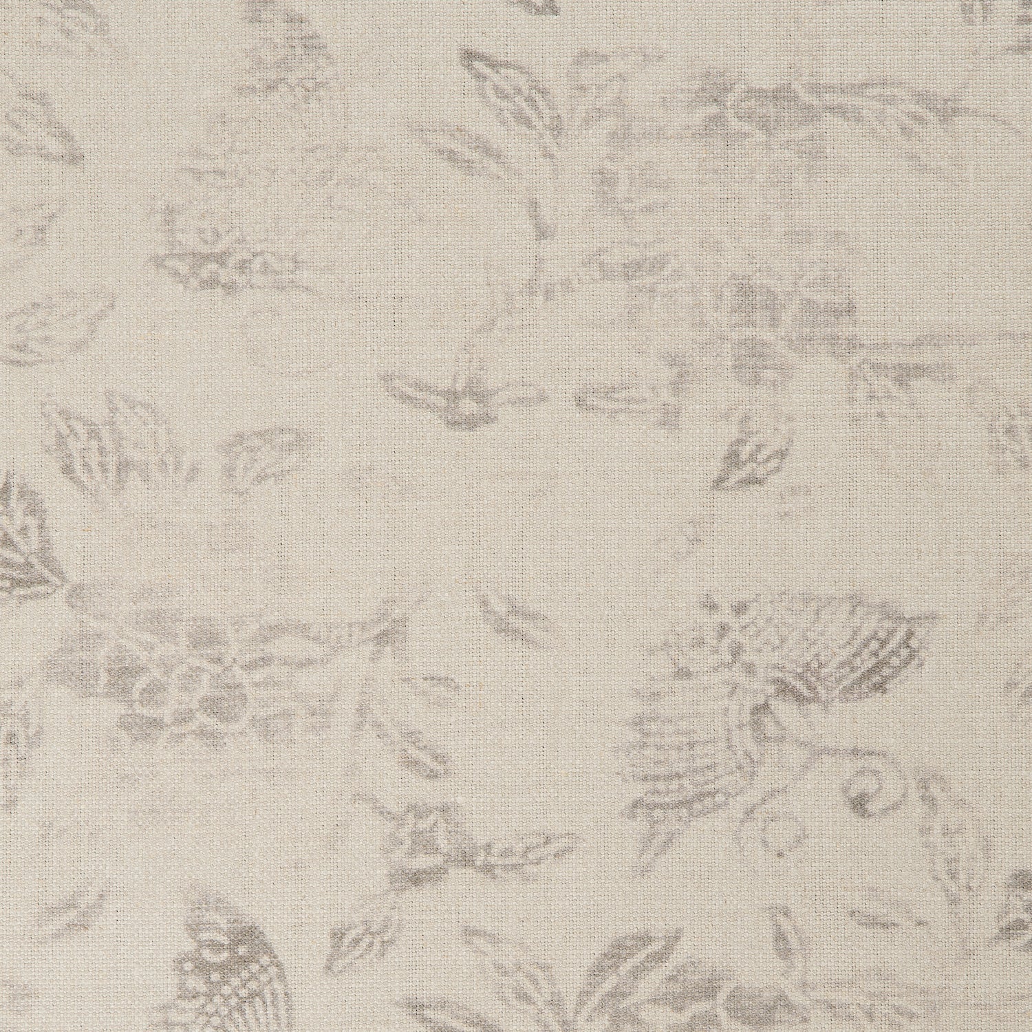 Detail of a printed linen fabric in a repeating flower and butterfly pattern in misty brown on a cream field.