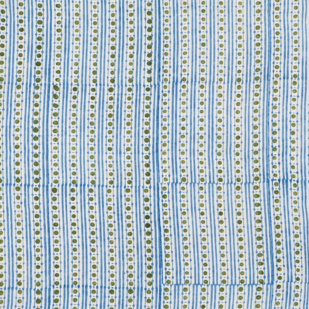 Detail of fabric in a geometric striped print in green and blue on a white field.