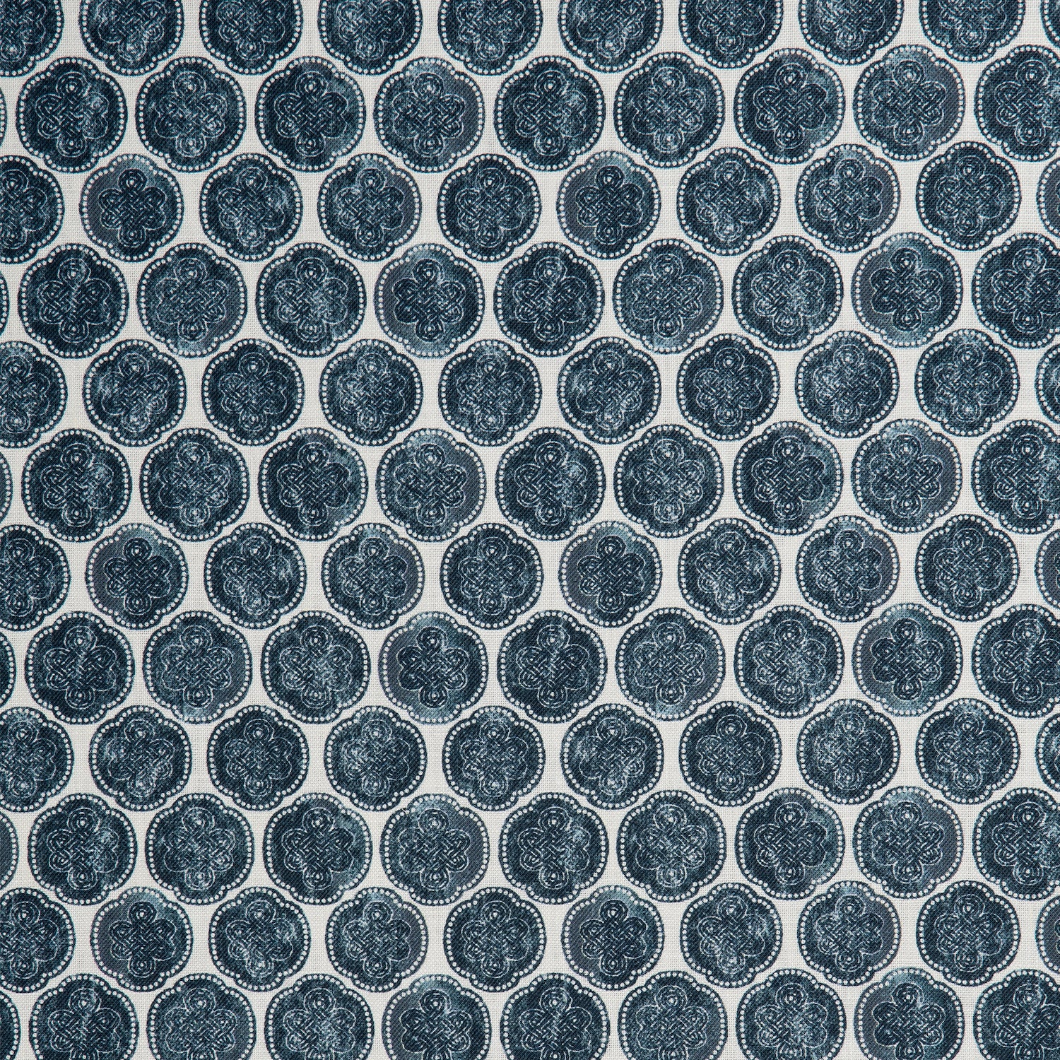 Detail of a printed linen fabric in a repeating knotted pattern in indigo on a white field.