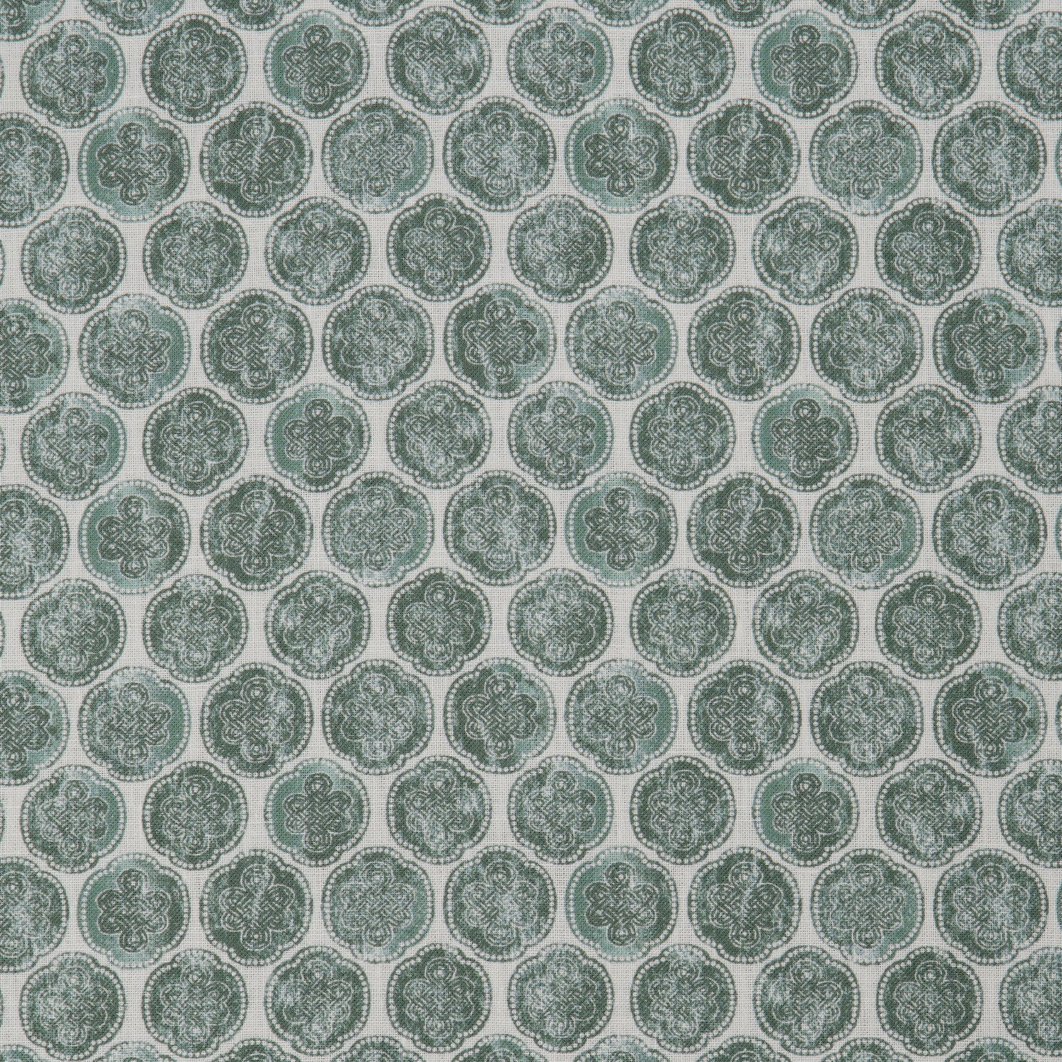 Detail of a printed linen fabric in a repeating knotted pattern in jade on a white field.