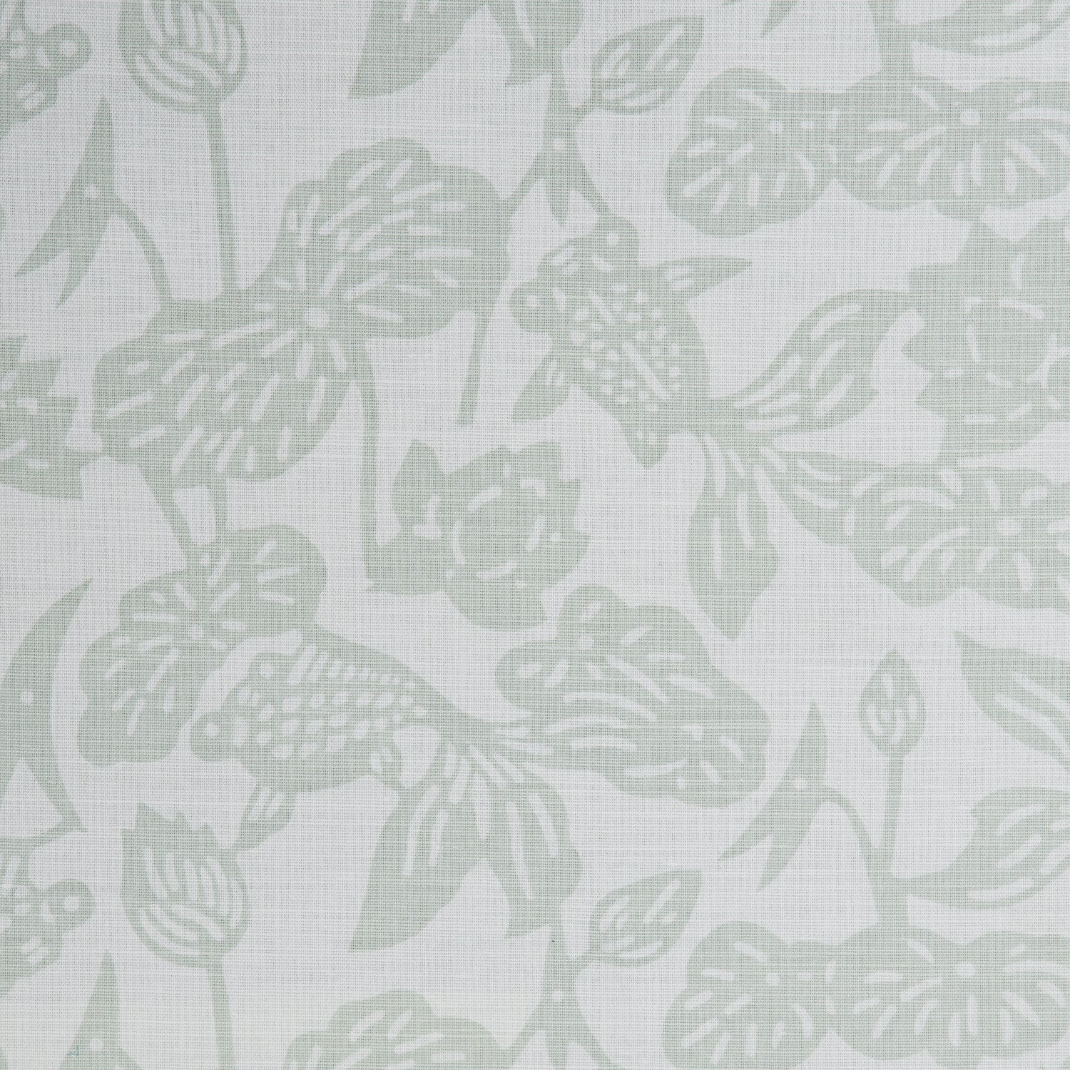 Detail of a cotton fabric in a repeating fish and leaf pattern in light green on a gray field.