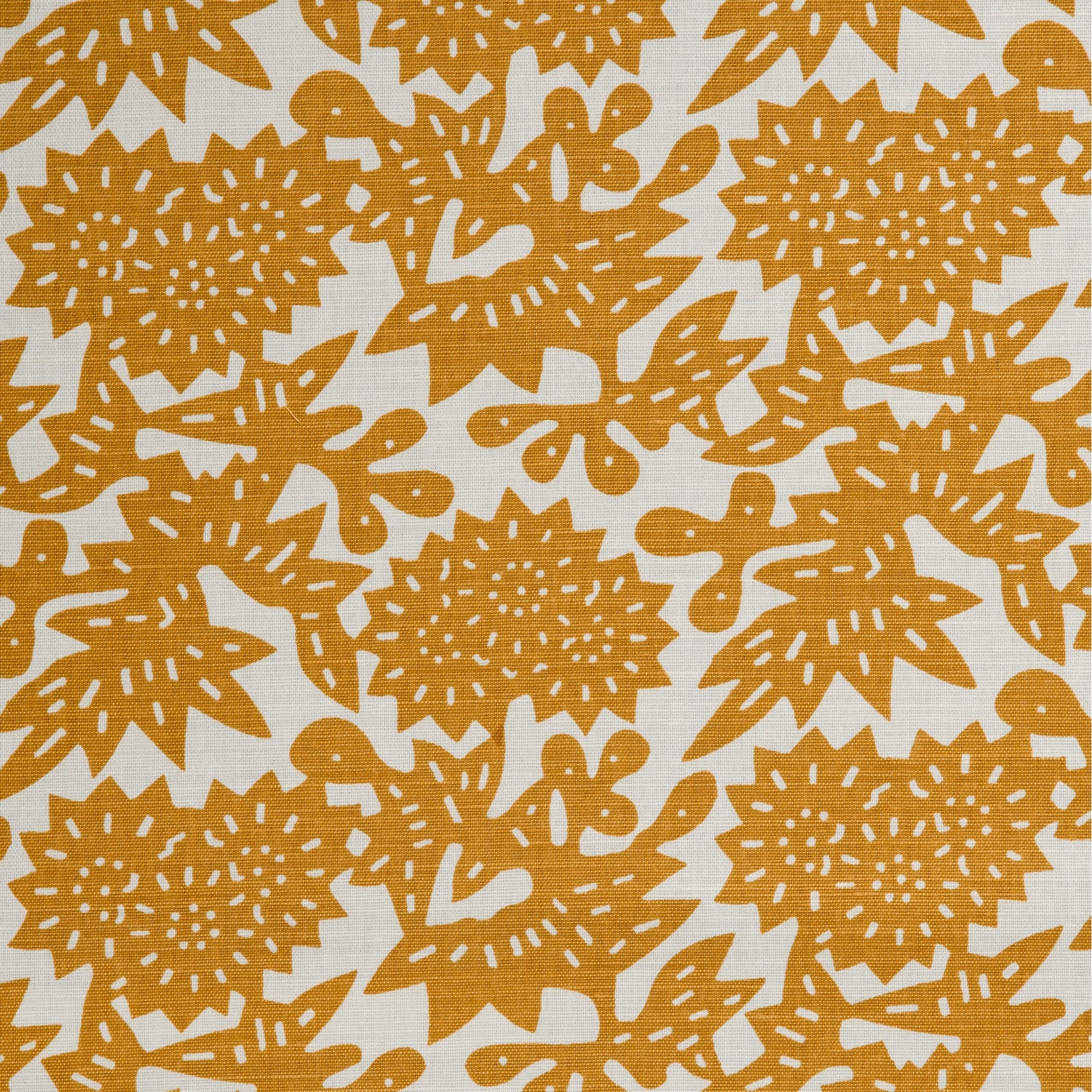Detail of a linen-cotton fabric in a repeating geometric flower pattern in burnt orange on a white field.