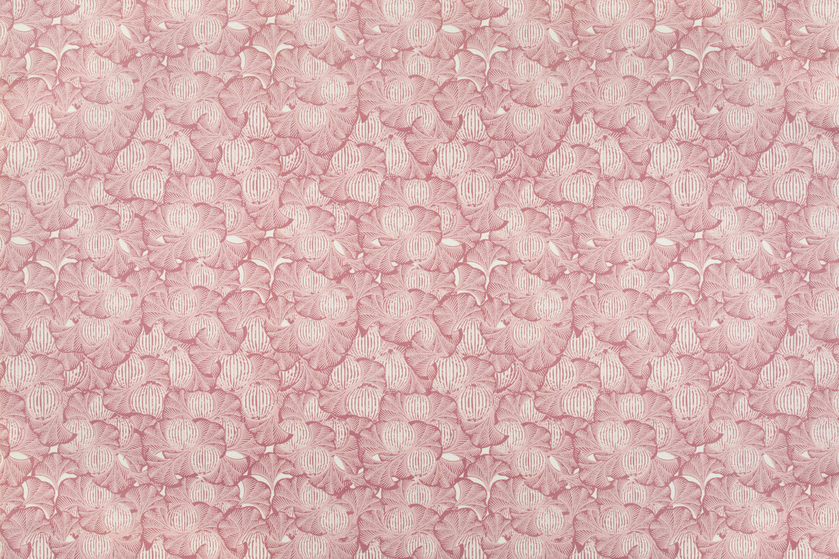 Detail of fabric in a dense petal print in shades of pink on a white field.