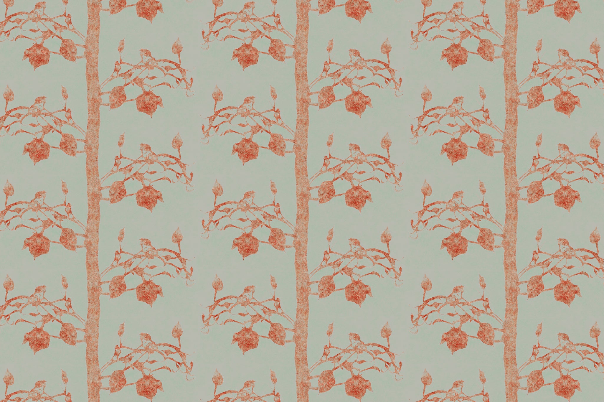 Detail of fabric in a linear tree and leaf print in burnt orange on a light green field.