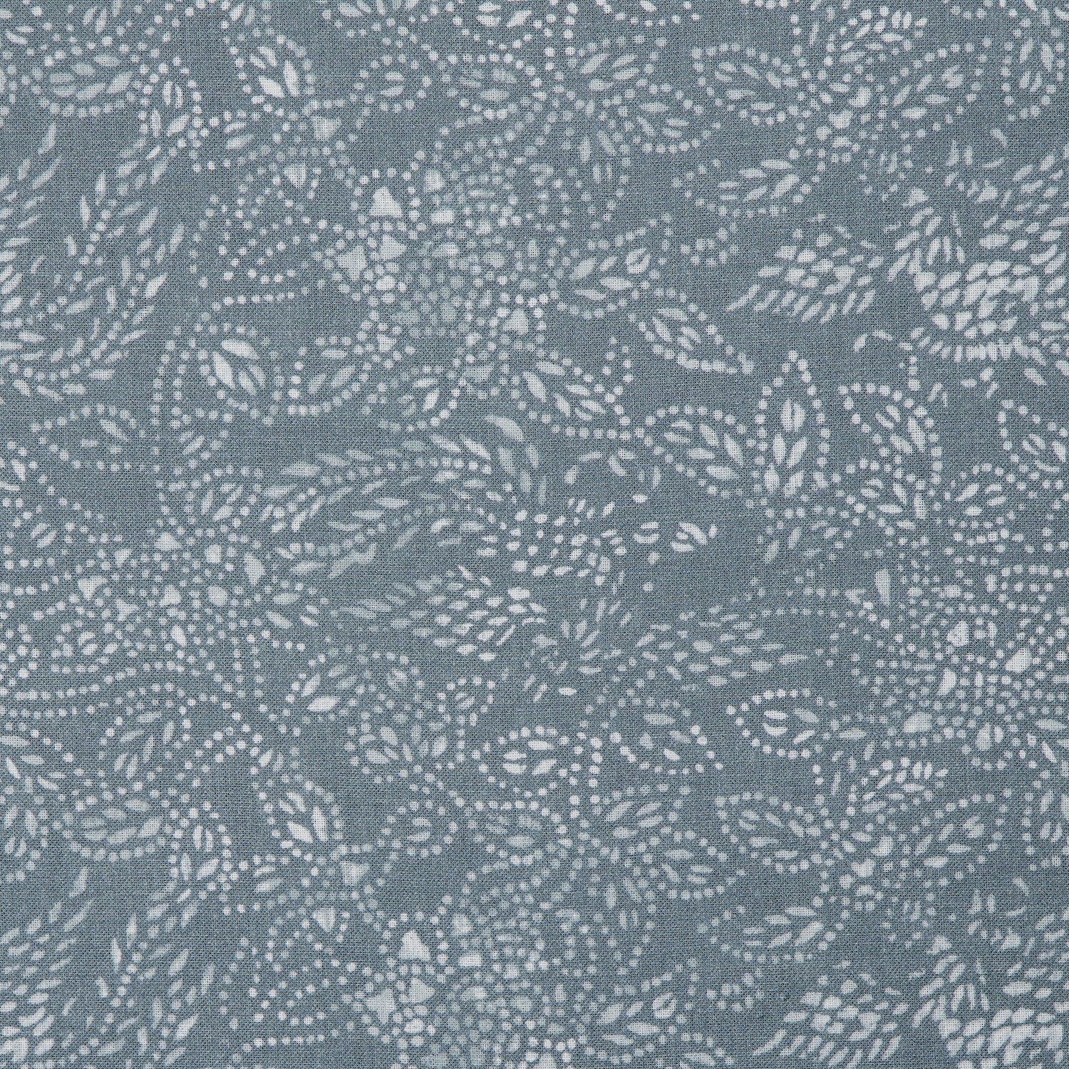Detail of a linen fabric in a dotted leaf pattern in white on a dusty blue field.