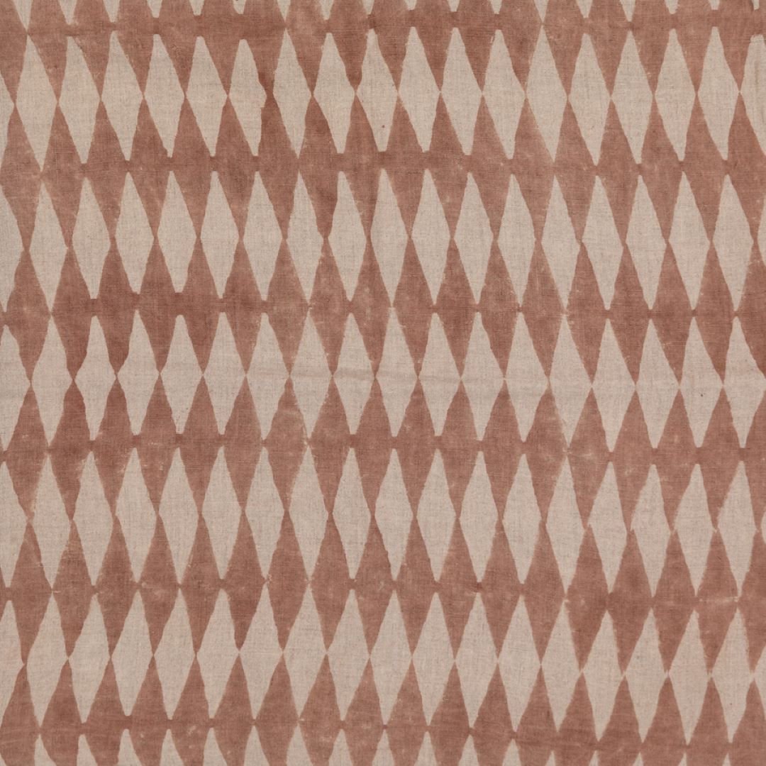 Detail of fabric in a diamond stripe print in brown on a tan field.