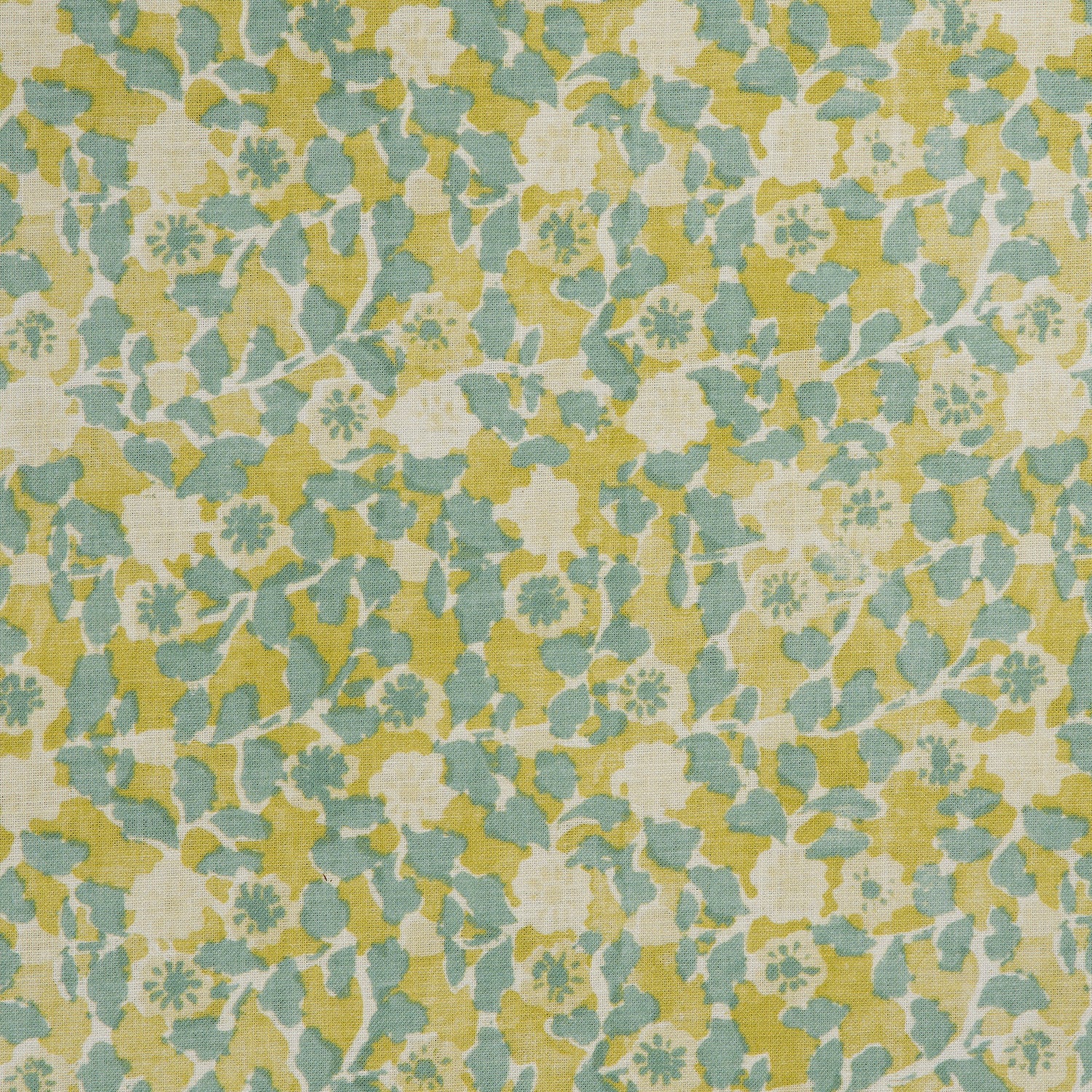 Detail of a linen fabric in a painterly floral pattern in mustard and blue on a cream field.