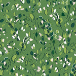 Detail of fabric in a painterly leaf print in shades of green and white on a kelly green field.