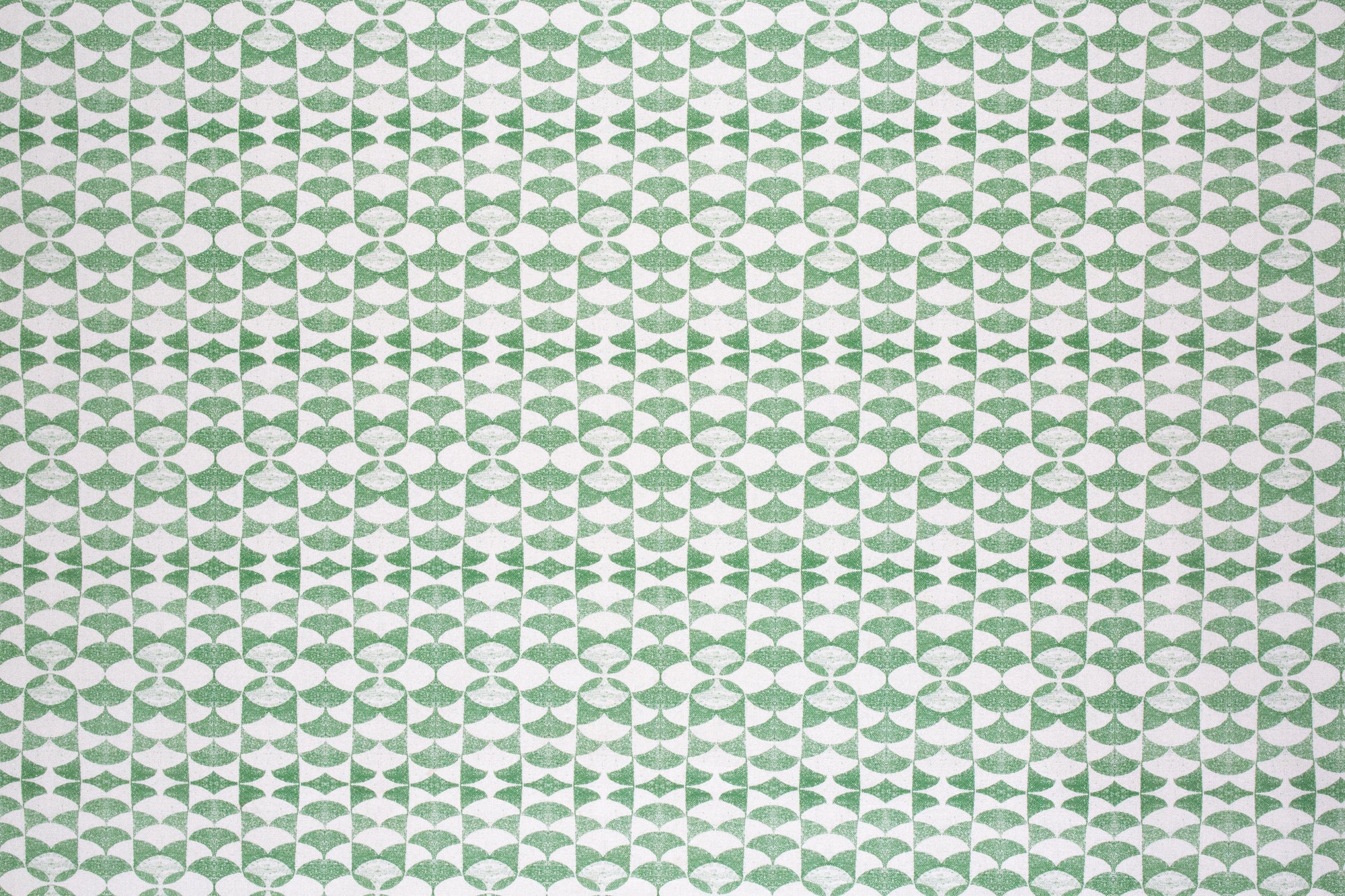 Detail of fabric in a geometric stripe pattern in green on a white field.