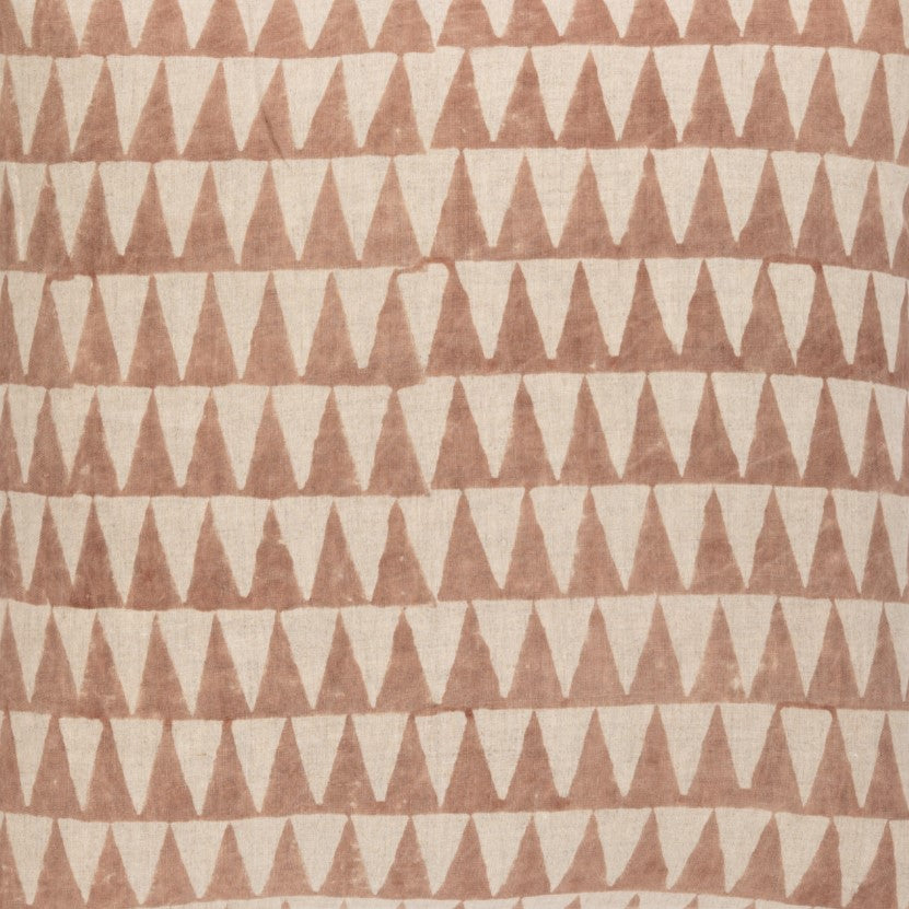 Detail of fabric in a repeating triangle print in dusty brown on a tan field.