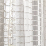 Draped sheer fabric in a wavy stripe pattern in ivory.
