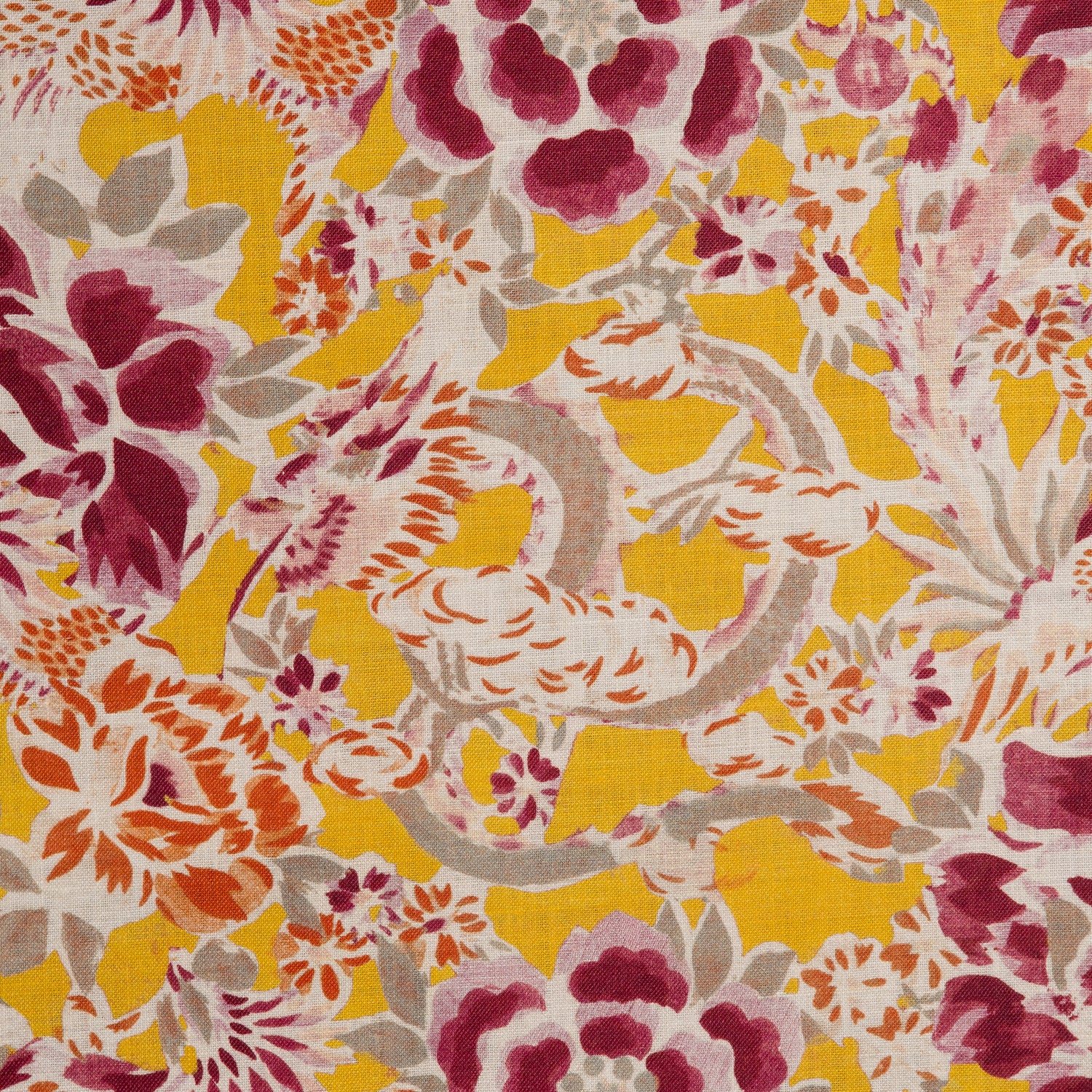 Detail of a linen fabric in a painterly floral pattern in shades of white, orange and purple on a mustard field.