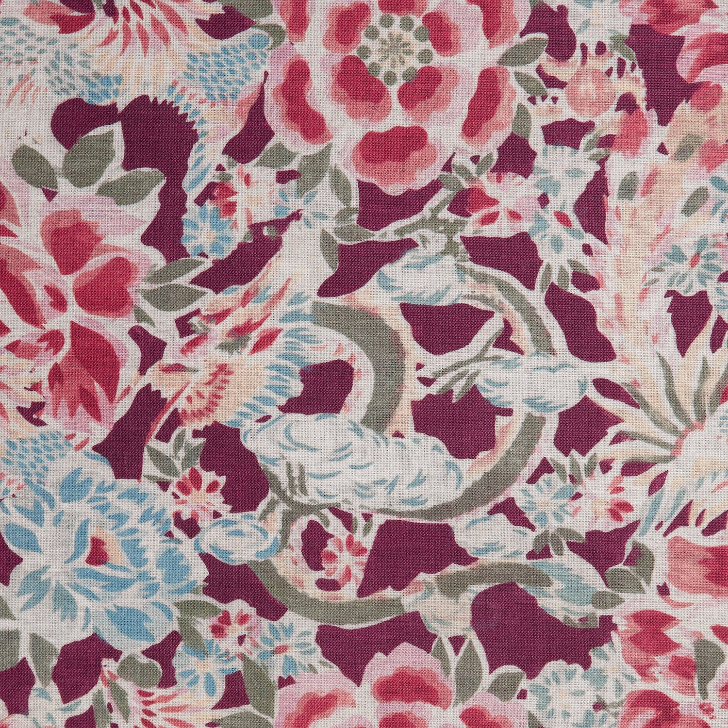Detail of a linen fabric in a painterly floral pattern in shades of blue, green and pink on a maroon field.
