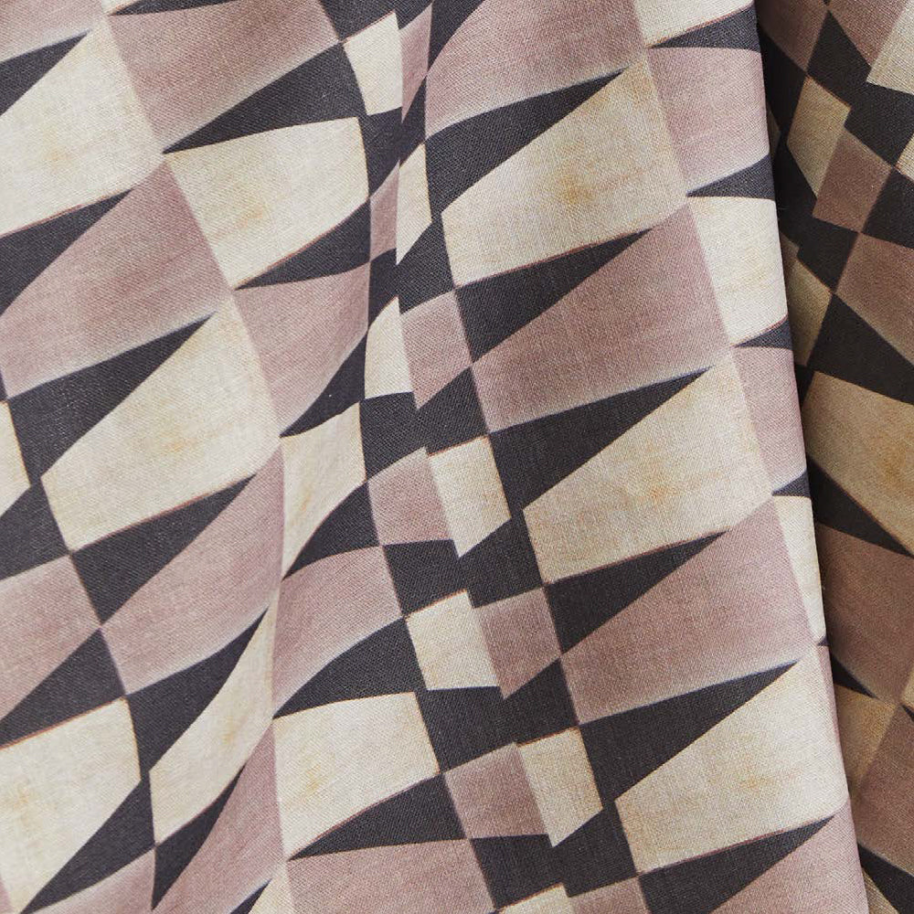 Draped fabric yardage in a striped triangle print in shades of purple and cream.