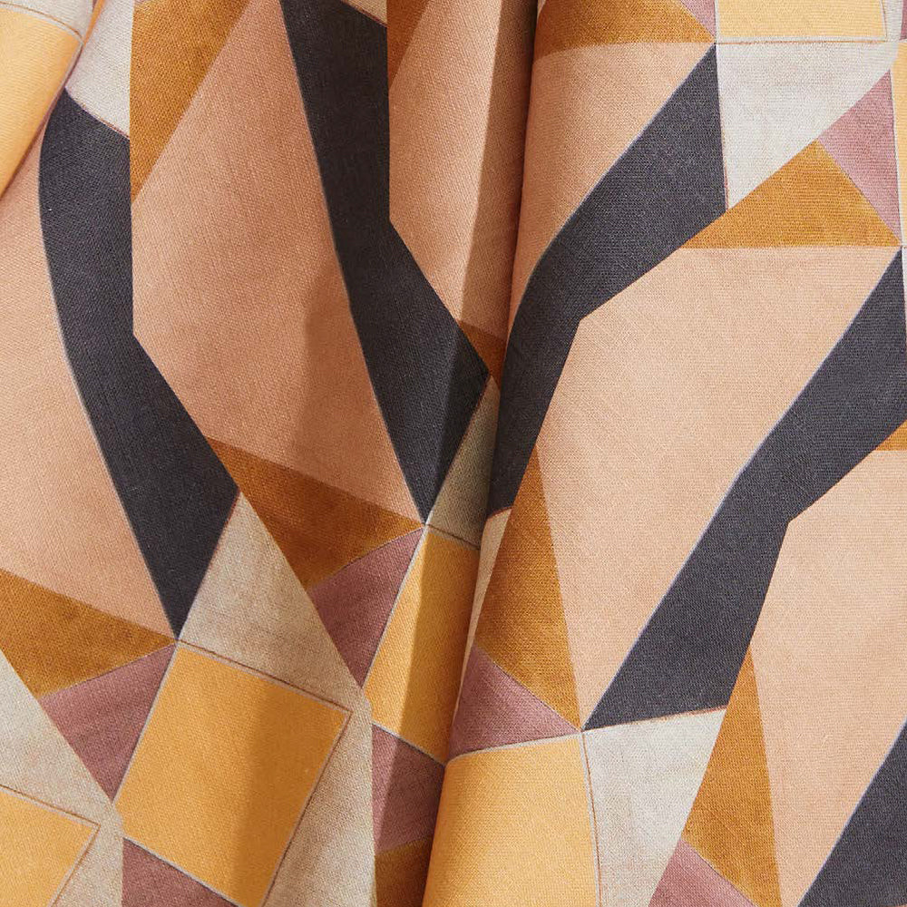 Draped fabric yardage in a striped triangle print in shades of orange, purple, peach and cream.